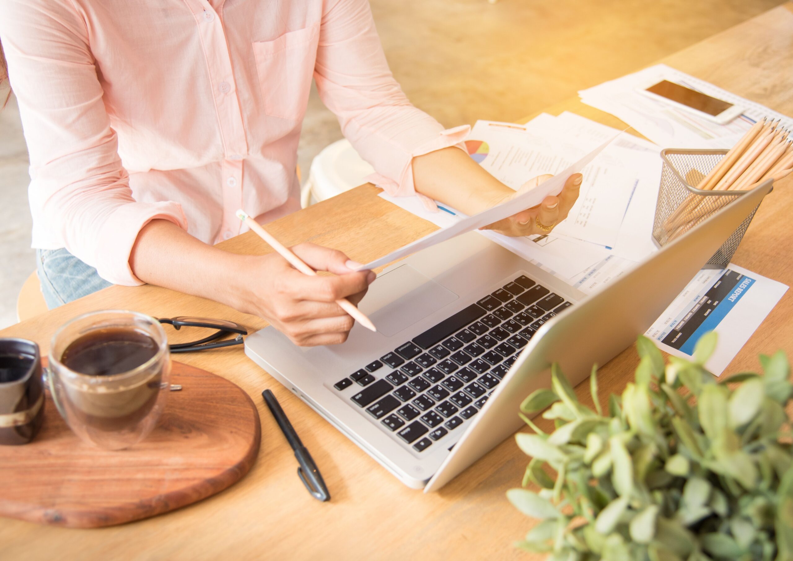 Marketing professional reviewing campaign performance reports at her desk